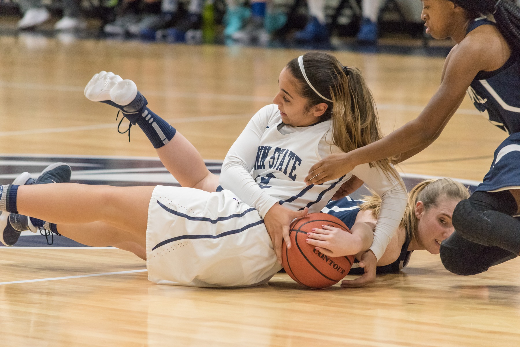 Corina Rivera (white jersey) fights for a loose ball against Penn State Fayette Friday, Jan. 19.