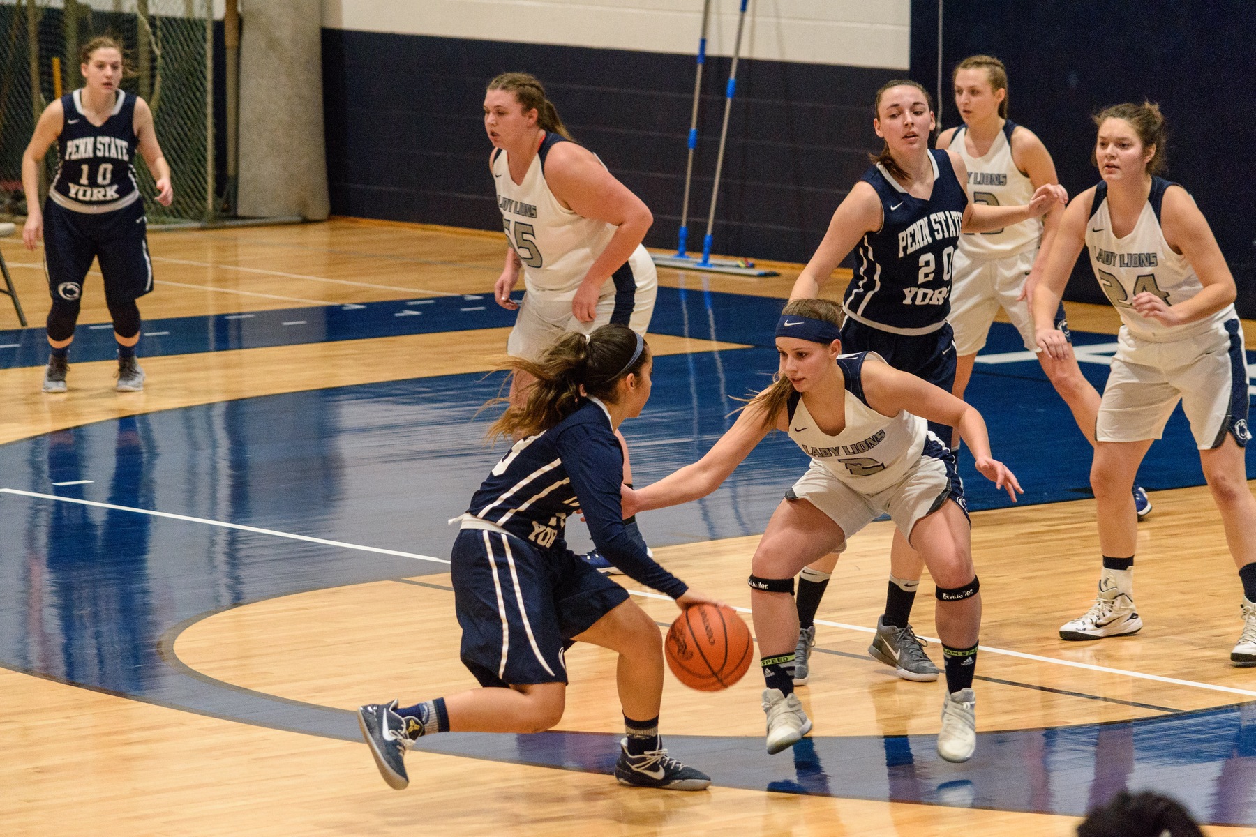 Corina Rivera (with ball) tries to find an opening in the Penn State Schuylkill defense as Karra Thomason (#20) looks on.